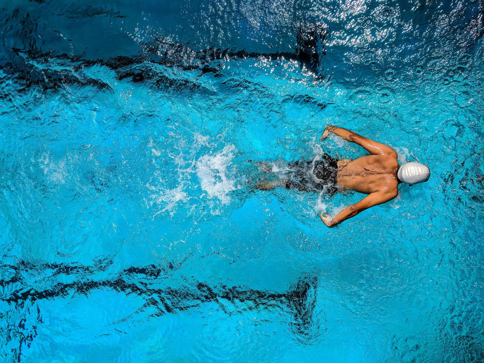 Person Swimming on Body of Water. jenniferanistonbody.com