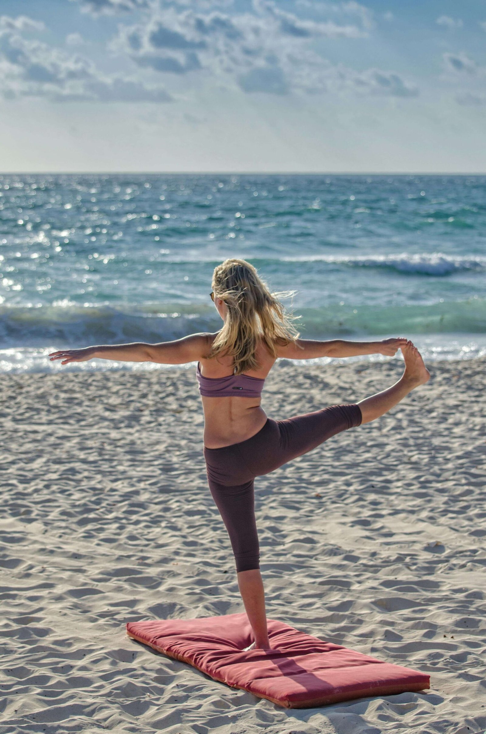 Woman Doing Yoga on Seashore. jenniferanistonbody.com