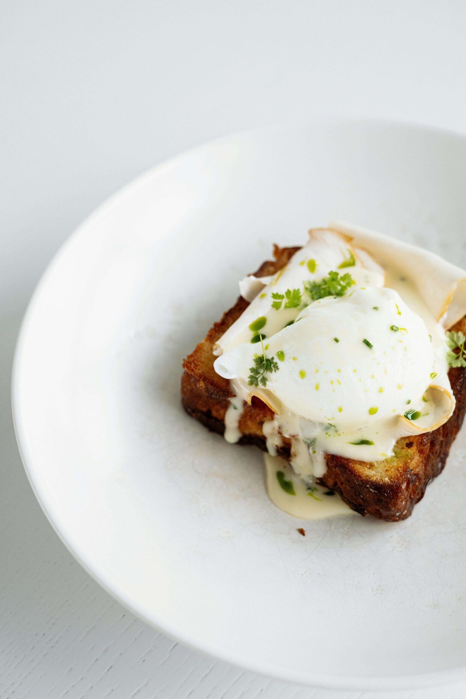 Brown Bread With White Cream and Green Vegetable on White Ceramic Plate. jenniferanistonbody.com